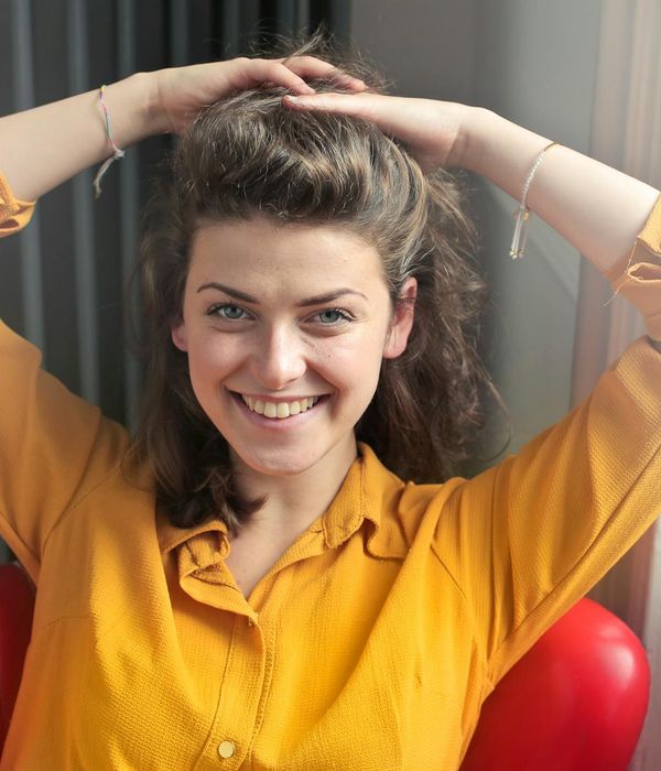 Portrait of a happy and relaxed woman sitting in a bright room.