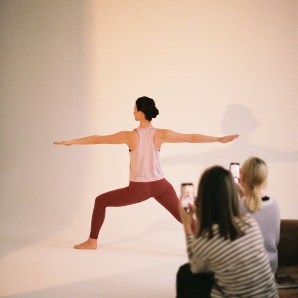 Woman in a peaceful yoga pose inside a modern studio.
